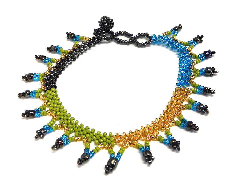 Handmade Czech glass seed bead anklet with V-shaped beaded fringe dangles in lime green, turquoise blue, gold, and dark brown color combination.