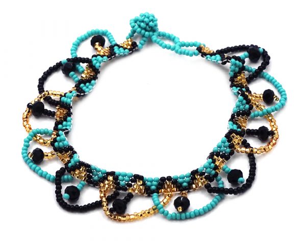 Handmade Czech glass seed bead and crystal bead anklet with tribal pattern design and beaded loop fringe dangles in turquoise mint, gold, and black color combination.