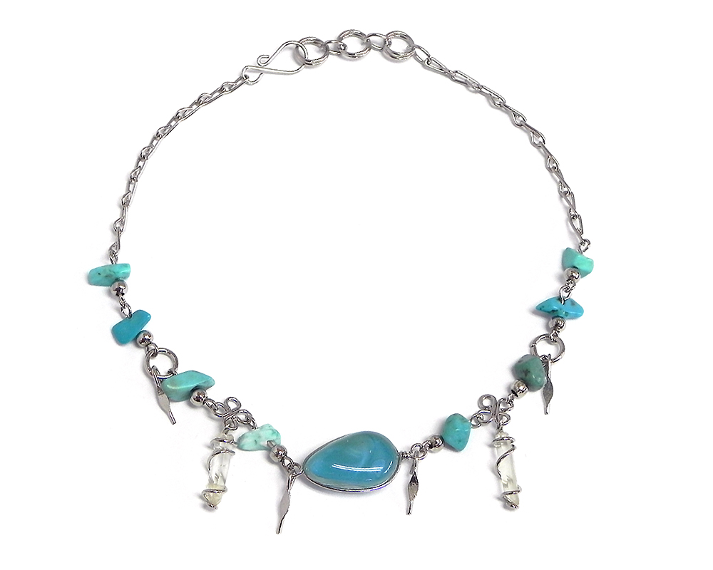 Handmade chip stone alpaca silver metal chain anklet with teardrop-shaped cat's eye glass bead, two wire wrapped natural clear quartz crystal points, and metal dangles in turquoise color.