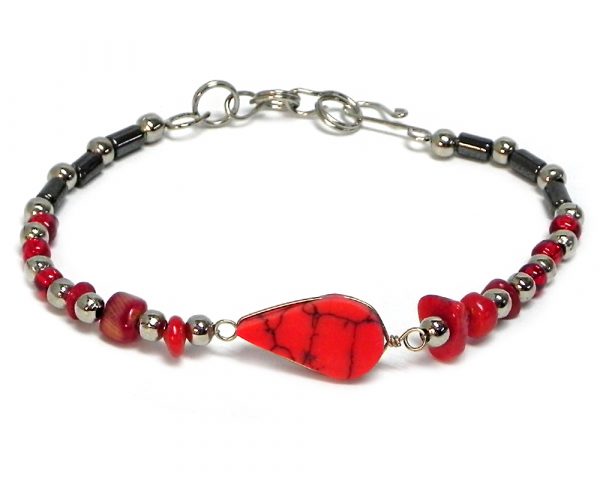 Handmade hematite, chip stone, and silver metal seed bead bracelet with teardrop-cut gemstone cabochon centerpiece in red howlite.