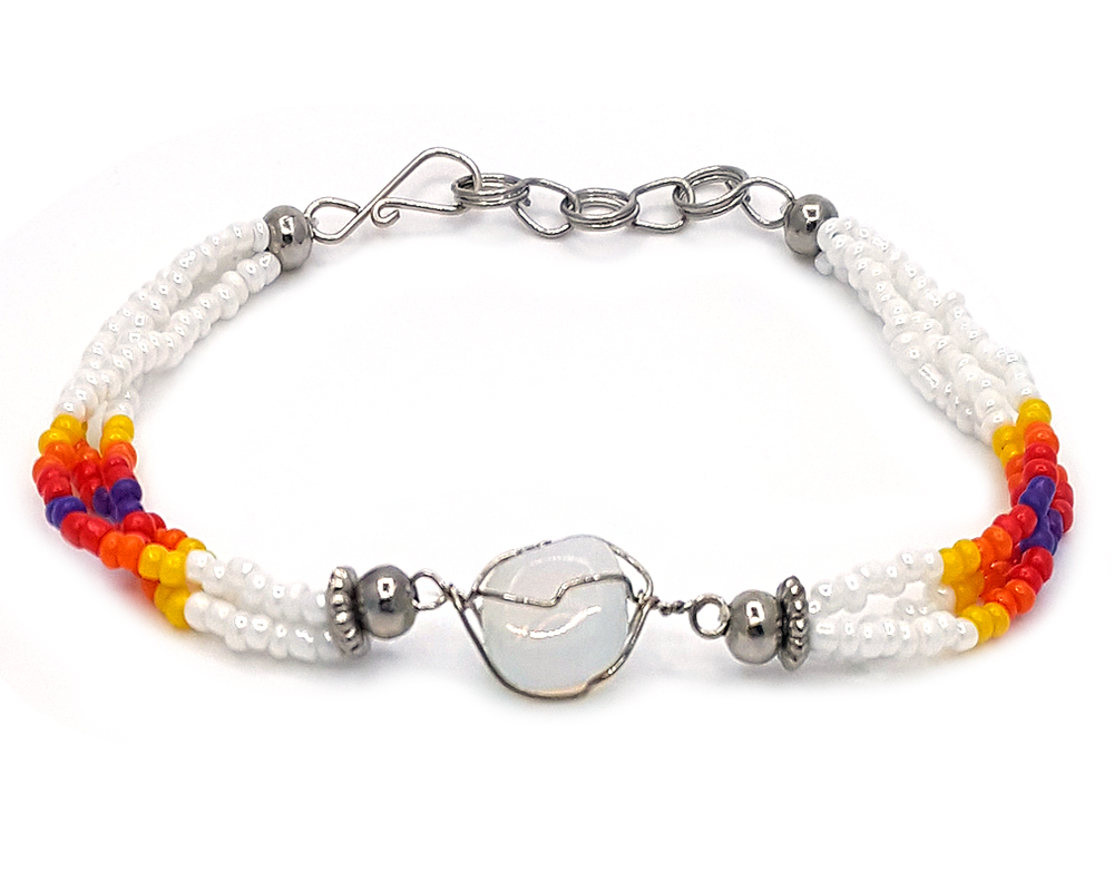 Handmade Native American inspired multicolored seed bead multi strand bracelet with silver metal wire wrapped tumbled iridescent opalite gemstone crystal centerpiece in white, yellow, orange, red, and dark purple color combination.