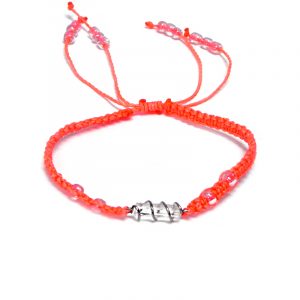 Handmade macramé braided string pull tie bracelet with silver metal wire wrapped clear quartz crystal centerpiece in neon salmon pink color.