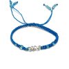 Handmade macramé braided string pull tie bracelet with silver metal wire wrapped clear quartz crystal centerpiece in turquoise blue color.