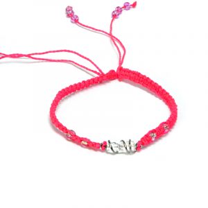 Handmade macramé braided string pull tie bracelet with silver metal wire wrapped clear quartz crystal centerpiece in neon pink color.