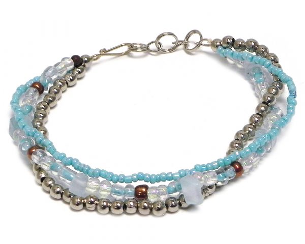 Handmade large seed bead and silver metal bead thick multi strand bracelet with chip stones in light blue and iridescent white color combination.