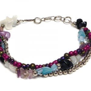 Handmade chip stone, large seed bead, and silver metal bead thick multi strand bracelet in purple, navy blue, light blue, and white color combination.