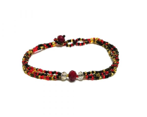 Handmade Czech glass seed bead multi strand bracelet with triple crystal bead centerpiece in red, gold, dark brown, and black color combination.