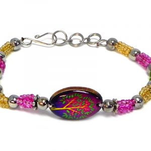 Handmade seed bead and silver metal bead rope-like bracelet with oval-shaped acrylic New Age themed tree of life graphic design centerpiece in magenta pink, purple, gold, and lime green color combination.