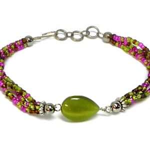 Handmade multicolored seed bead multi strand bracelet with teardrop-shaped cat’s eye glass bead centerpiece in olive green, magenta pink, and brown color combination.