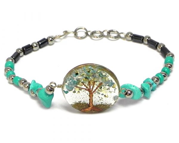 Handmade hematite, chip stone, and silver metal seed bead bracelet with round-shaped clear acrylic resin, copper wire, and crushed chip stone inlay tree of life centerpiece in mint turquoise color.
