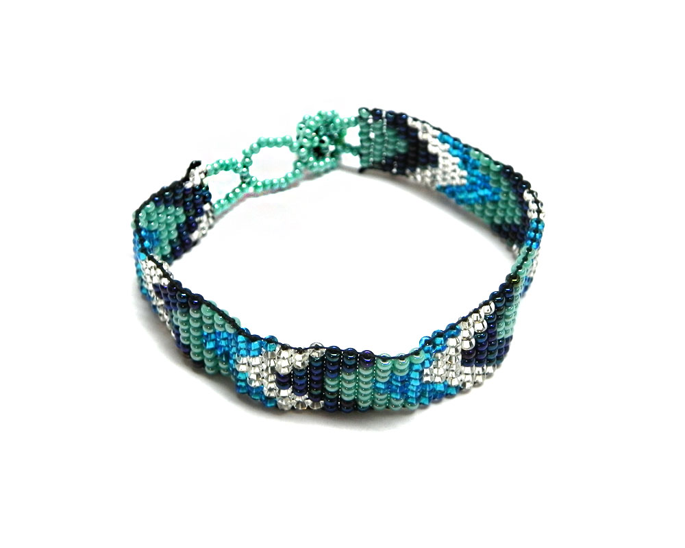 Handmade Czech glass seed bead thin strap bracelet with chevron striped pattern design in turquoise blue, mint, navy, and silver color combination.