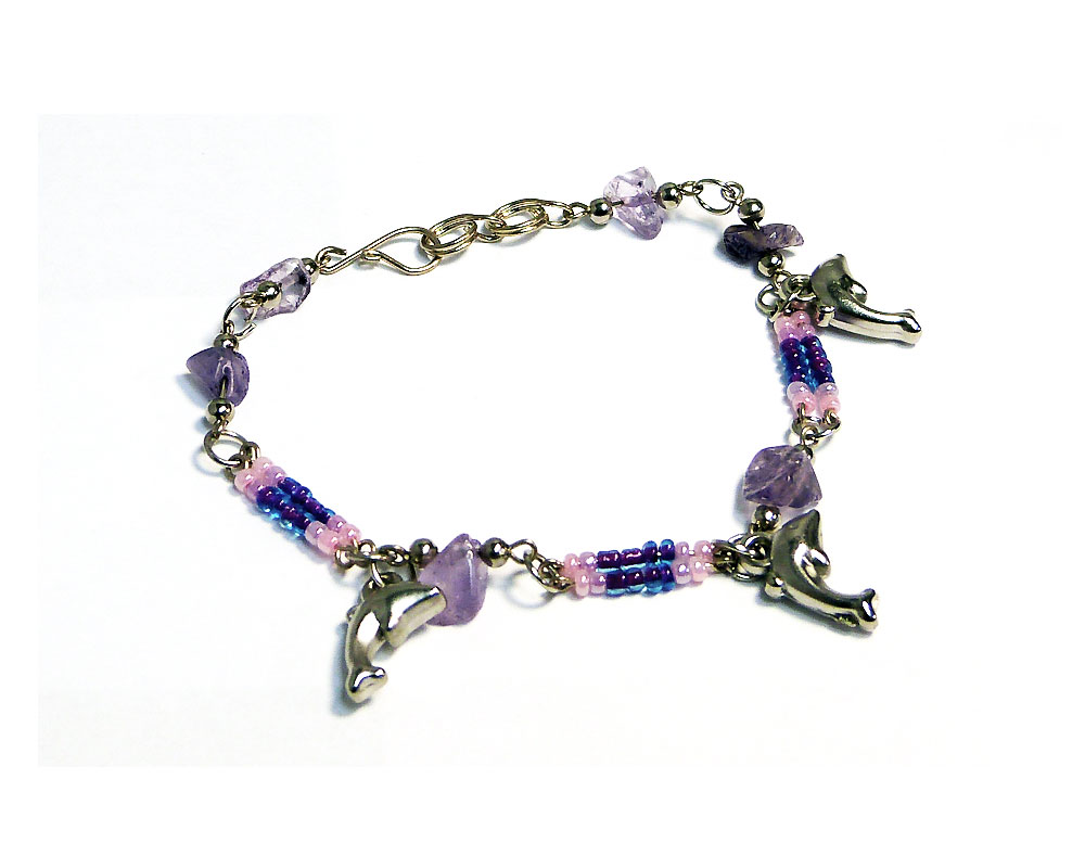Handmade seed bead and chip stone alpaca silver metal chain bracelet with three dolphin charm dangles in light pink, lavender, and purple color combination.
