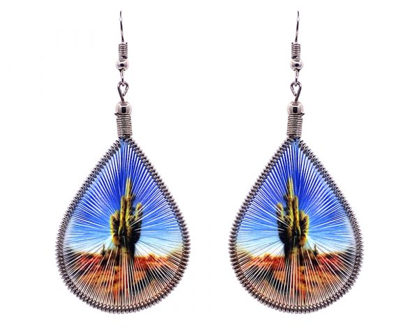 Teardrop-shaped thread dangle earrings with alpaca silver wire and Saguaro cactus graphic image in lime green, light blue, and tan color combination.