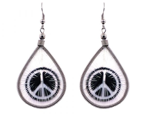 Teardrop-shaped thread dangle earrings with alpaca silver wire and peace sign graphic image in white and black color combination.