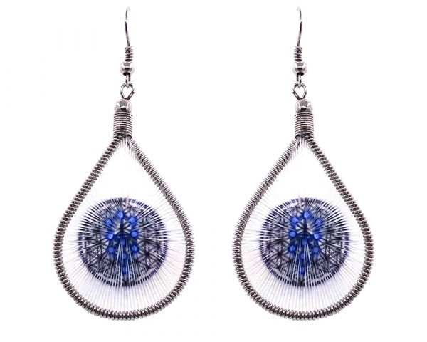 Teardrop-shaped thread dangle earrings with alpaca silver wire and Kabbalah Flower of Life sacred geometry graphic image in white, black, and blue color combination.