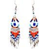Native American inspired teardrop-shaped beaded chip stone earrings with long seed bead and alpaca silver metal dangles in blue, orange, light blue, and white color combination.