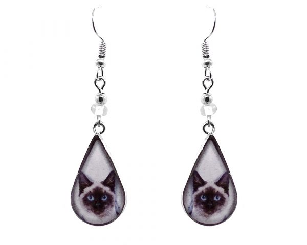Teardrop-shaped Siamese cat face graphic acrylic dangle earrings with silver metal setting and beaded metal hooks in white, dark brown, and beige color combination.