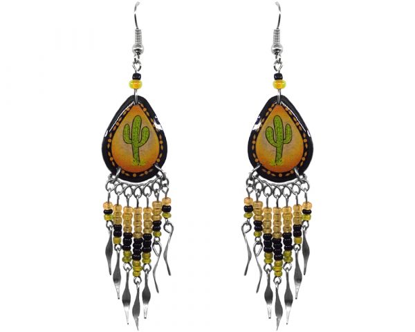 Handmade teardrop-shaped ceramic earrings with handpainted tribal pattern saguaro cactus graphic design and long seed bead and alpaca silver metal dangles in golden yellow, orange, black, and lime green color combination.