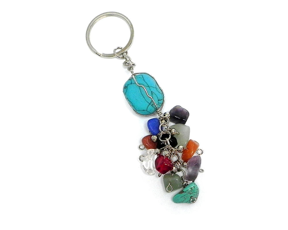 Handmade wire wrapped tumbled gemstone crystal with multicolored chip stone cluster dangle on silver metal key ring in turquoise blue howlite.