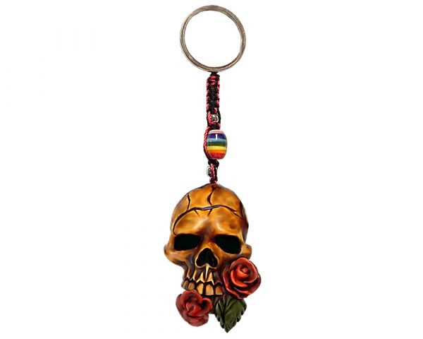 Durepox resin figurine keychain of a beige skull with red roses in its mouth.