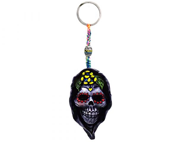 Handmade durepox resin figurine keychain of a hooded death sugar skull with multicolored floral designs.