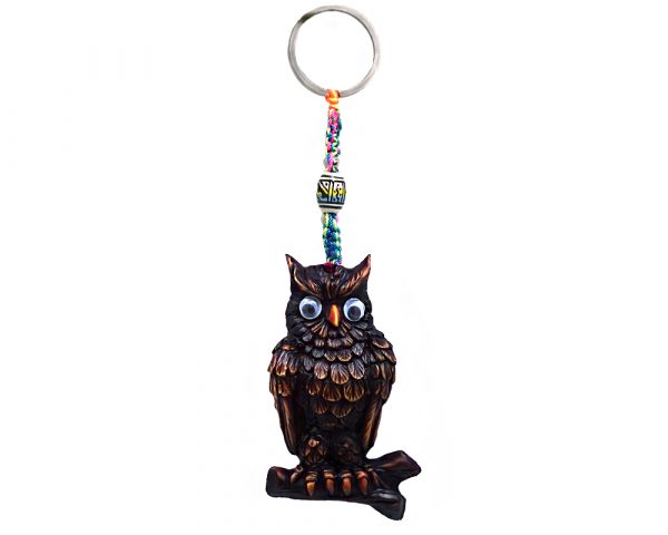 Handmade durepox resin figurine keychain of a perched owl on a branch with googly eyes in brown color.