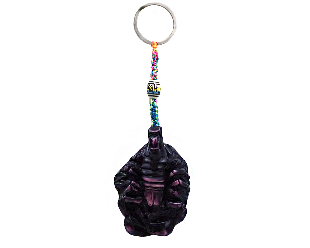 Handmade durepox resin figurine keychain of a dark purple scorpion.