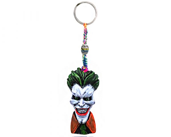 Handmade durepox resin figurine keychain of an evil clown character with a big head, creepy smile, green hair, and suit.