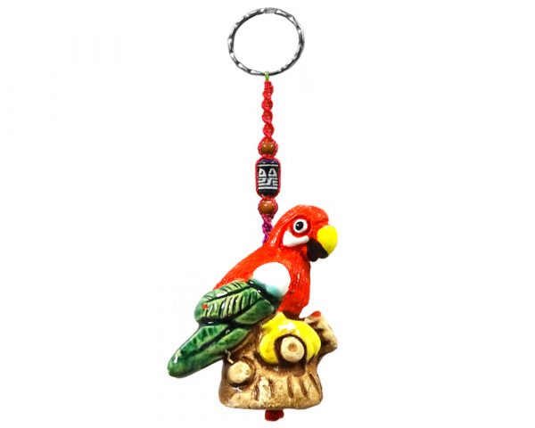 Handmade parrot animal keychain with handpainted ceramic, macramé string, a large bead, and metal keyring in red, white, green, and yellow color combination.
