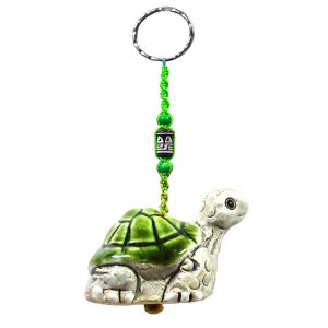 Handmade turtle animal keychain with handpainted ceramic, macramé string, a large bead, and metal keyring in green and gray color combination.
