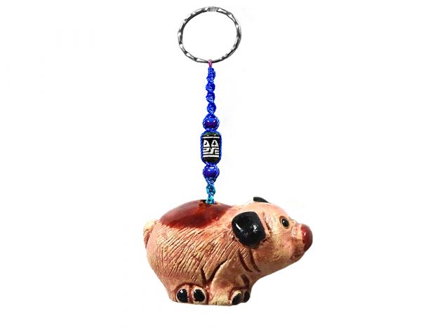 Handmade pig animal keychain with handpainted ceramic, macramé string, a large bead, and metal keyring in pink and black color combination.
