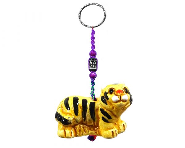 Handmade tiger animal keychain with handpainted ceramic, macramé string, a large bead, and metal keyring in golden yellow and black color combination.