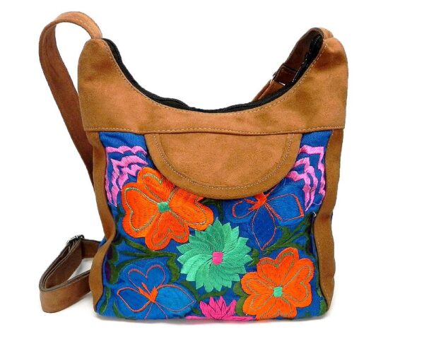 Square-shaped hobo crossbody purse bag with multicolored embroidered floral designs, brown vegan leather suede, and blue fabric.