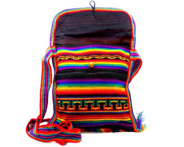 Handmade medium-sized slim square-shaped purse bag with multicolored tribal print striped pattern material (or manta Inca) and fringe in rainbow colors.