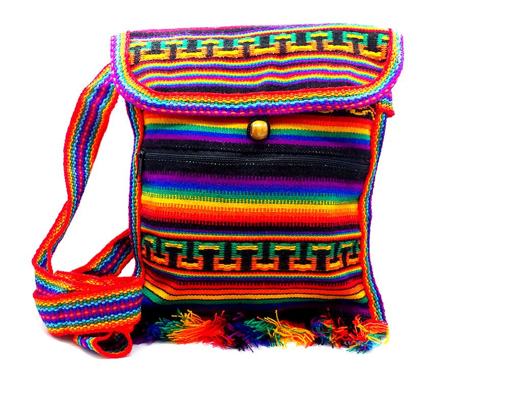 Handmade medium-sized slim square-shaped purse bag with multicolored tribal print striped pattern material (or manta Inca) and fringe in rainbow colors.