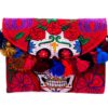 Handmade Day of the Dead sugar skull purse with embroidered floral design, cotton pom poms, and crossbody strap in red and multicolored medium size.