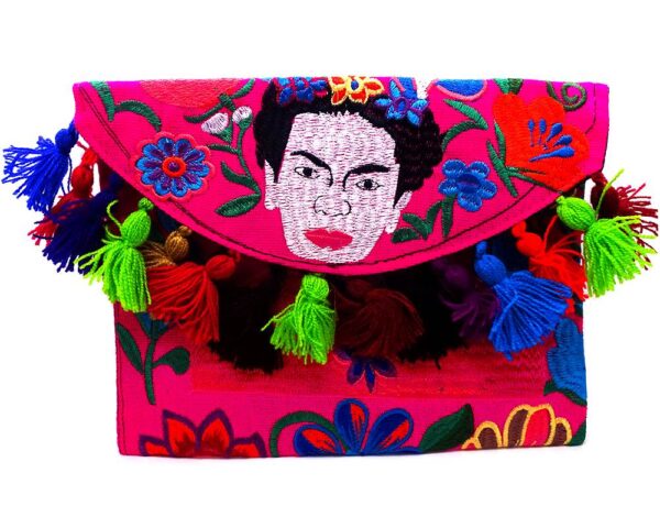 Handmade Frida inspired purse bag with floral embroidered cotton material, pom pom fringe, magnetic snap closure, and a crossbody strap in hot pink and multicolored color combination.