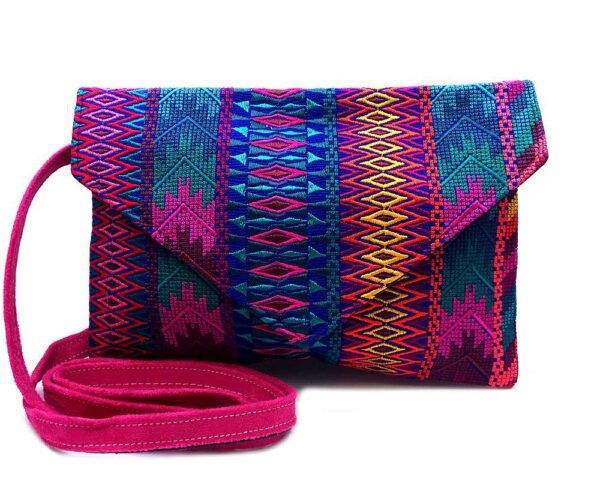 Handmade slim envelope purse bag with tribal huipil embroidered cotton material, magnetic snap closure, and a crossbody strap in blue, hot pink, and multicolored color combination.
