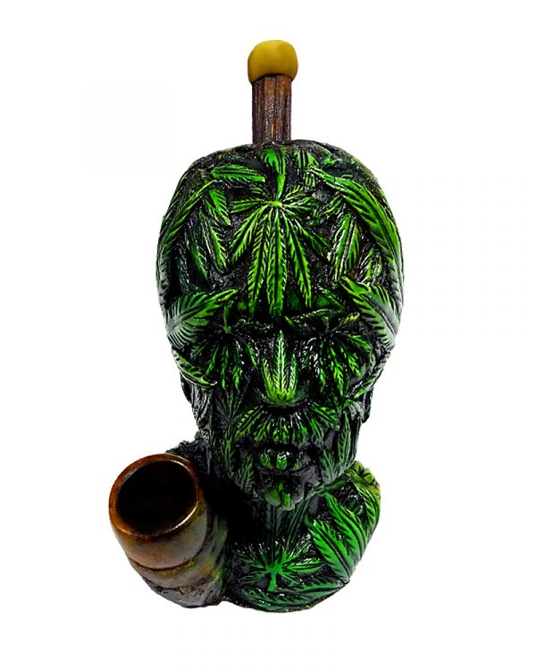 Handcrafted medium-sized tobacco smoking hand pipe of a head covered with multiple green hemp leaves.