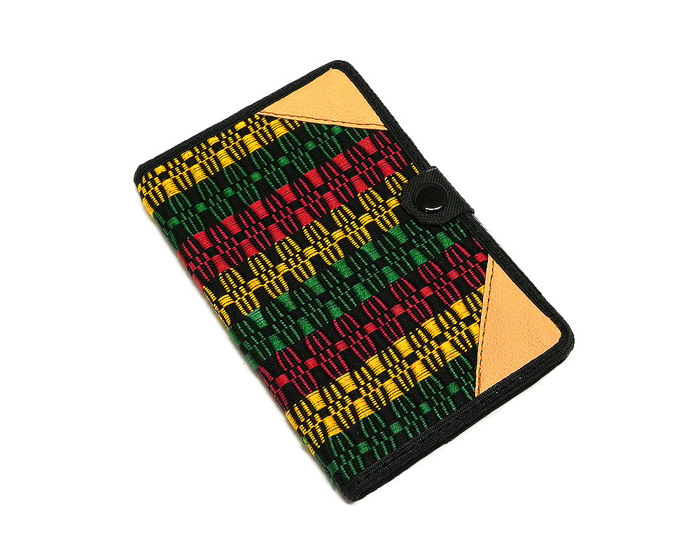 Handmade small woven cotton refillable notebook cover with multicolored stripes in black and Rasta colors.