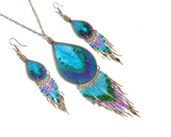 Handmade beaded teardrop-shaped silk thread necklace and matching earrings with long seed bead and alpaca silver metal dangles in turquoise blue, green, and purple color combination.