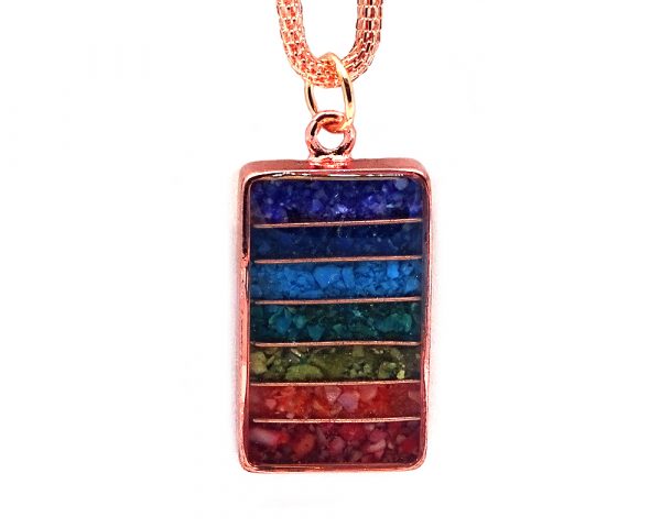 Handmade rectangle-shaped acrylic resin, copper wire, and crushed chip stone inlay orgonite pendant with 7 chakra rainbow striped pattern and copper metal setting on adjustable copper chain necklace.