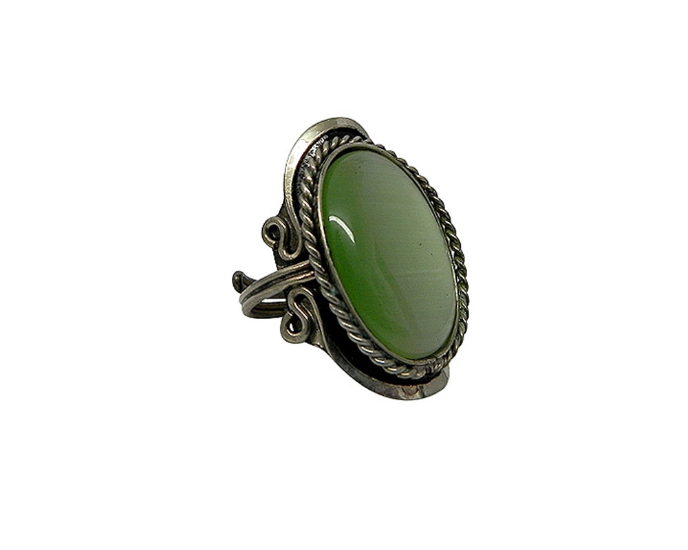 Handmade large oval-shaped cat's eye glass bead cabochon on adjustable alpaca silver metal ring with rope edge border in light green color.