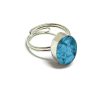 Handmade mini oval-shaped resin and crushed chip stone inlay cabochon on adjustable silver metal ring in turquoise blue color.
