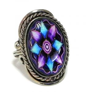 Handmade oval-shaped acrylic New Age themed floral mandala graphic design on alpaca silver metal ring with rope edge border in purple, lavender, light blue, turquoise, and black color combination.