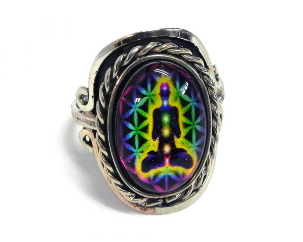 Handmade small oval-shaped acrylic New Age themed flower of life chakra graphic design on alpaca silver metal ring with rope edge border in rainbow multicolored color combination.
