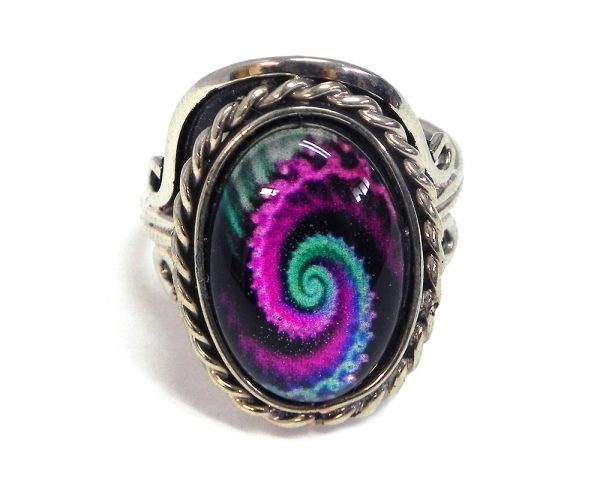 Handmade small oval-shaped acrylic New Age themed psychedelic fractal spiral graphic design on alpaca silver metal ring with rope edge border in magenta purple, mint, and black color combination.
