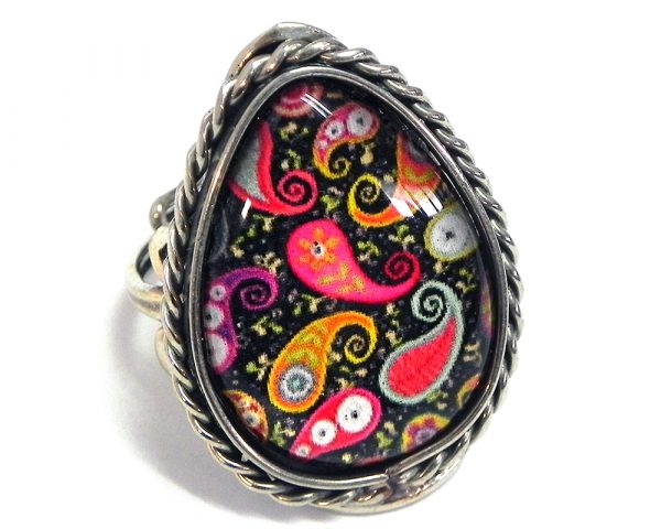 Teardrop-shaped acrylic New Age themed paisley graphic design on alpaca silver metal ring with rope edge border in black, hot pink, yellow, orange, and white color combination.