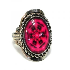 Handmade small oval-shaped acrylic New Age themed hexagonal mandala graphic design on alpaca silver metal ring with rope edge border in hot pink and black color combination.