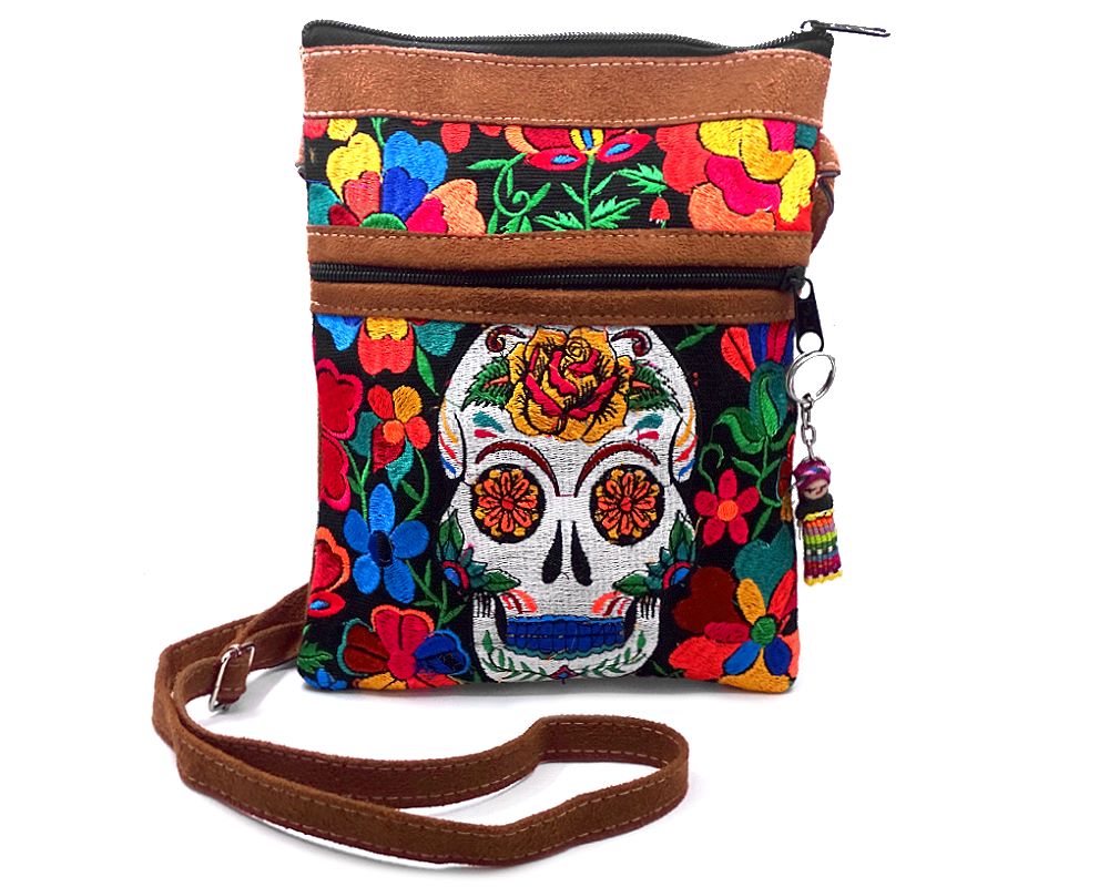 Handmade medium-sized slim rectangular brown vegan leather purse bag with cotton embroidered Day of the Dead sugar skull and floral designs in black and multicolored color combination.